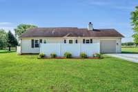 The rear of the home.  It features some additional privacy with the white vinyl fencing at the patio.