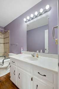 The second Bathroom is located in the hallway and it features a large vanity.