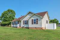 Another front view of this beautiful home.  The Central Heat & Air unit is located to the right side of the home and enclosed with the white vinyl fencing.