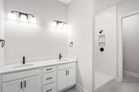 The primary bath has beautiful cabinetry, two sinks, tile shower walls and tile bathroom flooring plus large closet and separate water closet.