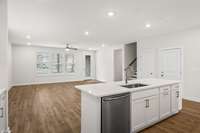 Dishwasher conveniently located in kitchen island, along with sink and double trash pull-out drawer!