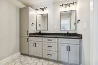 Large bathroom upstairs with new tile, new double vanity, leathered granite,mirrors,vanity lights, and black faucets.