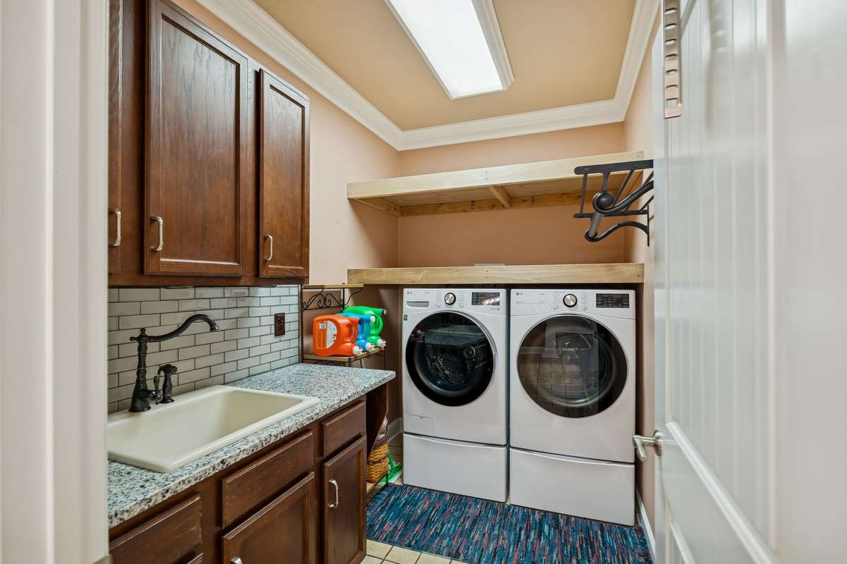 Spacious laundry room with sink and cabinets!