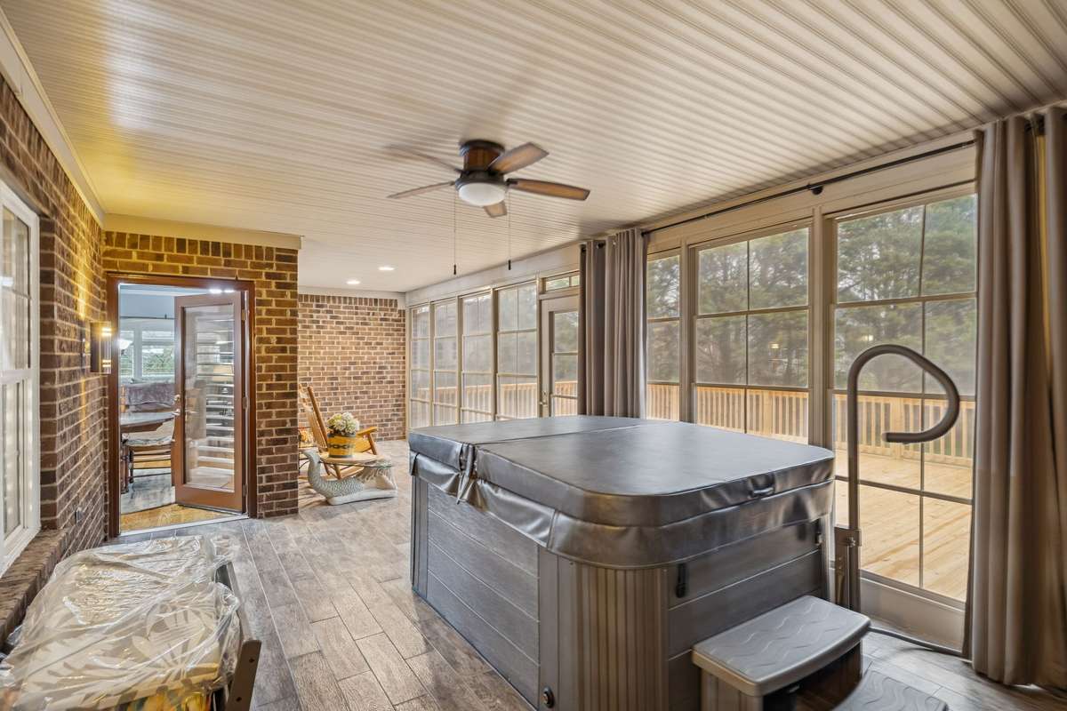 Large enclosed all weather back porch opens to big back deck!  Hot tub conveys!