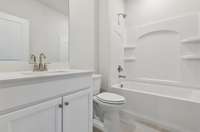 Canyon guest bath. Photo is of similar home, same plan. Colors, interior selections, elevations, garage swing, and upgrades may vary.