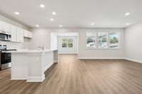 Canyon kitchen and dining space. Photo is of similar home, same plan. Colors, interior selections, elevations, garage swing, and upgrades may vary.