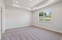 Canyon primary bedroom. Photo is of similar home, same plan. Colors, interior selections, elevations, garage swing, and upgrades may vary.