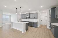 Darlington kitchen and dining from living space. Photo is of similar home, same plan. Colors, interior selections, elevations and upgrades may vary.