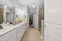 The Primary Bath has long oversized double vanities w/lots of drawer & cabinet storage, new paint & lighting, separate tiled shower and garden soaking tub, tile floors and nice linen closet across from the water closet.