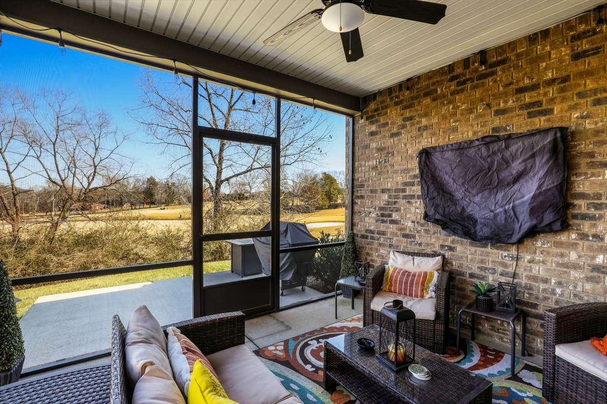 Screened porch with view of the golf course.