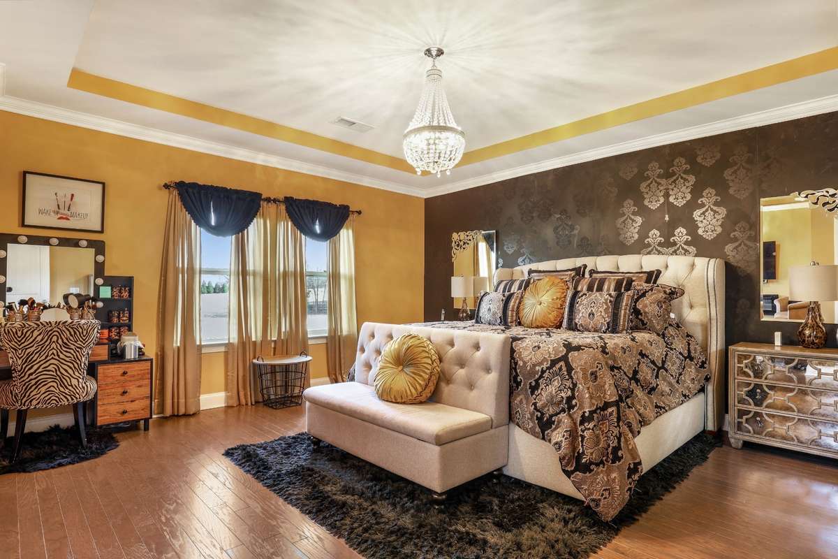 Master bedroom has a tray ceiling with upgraded lighting.