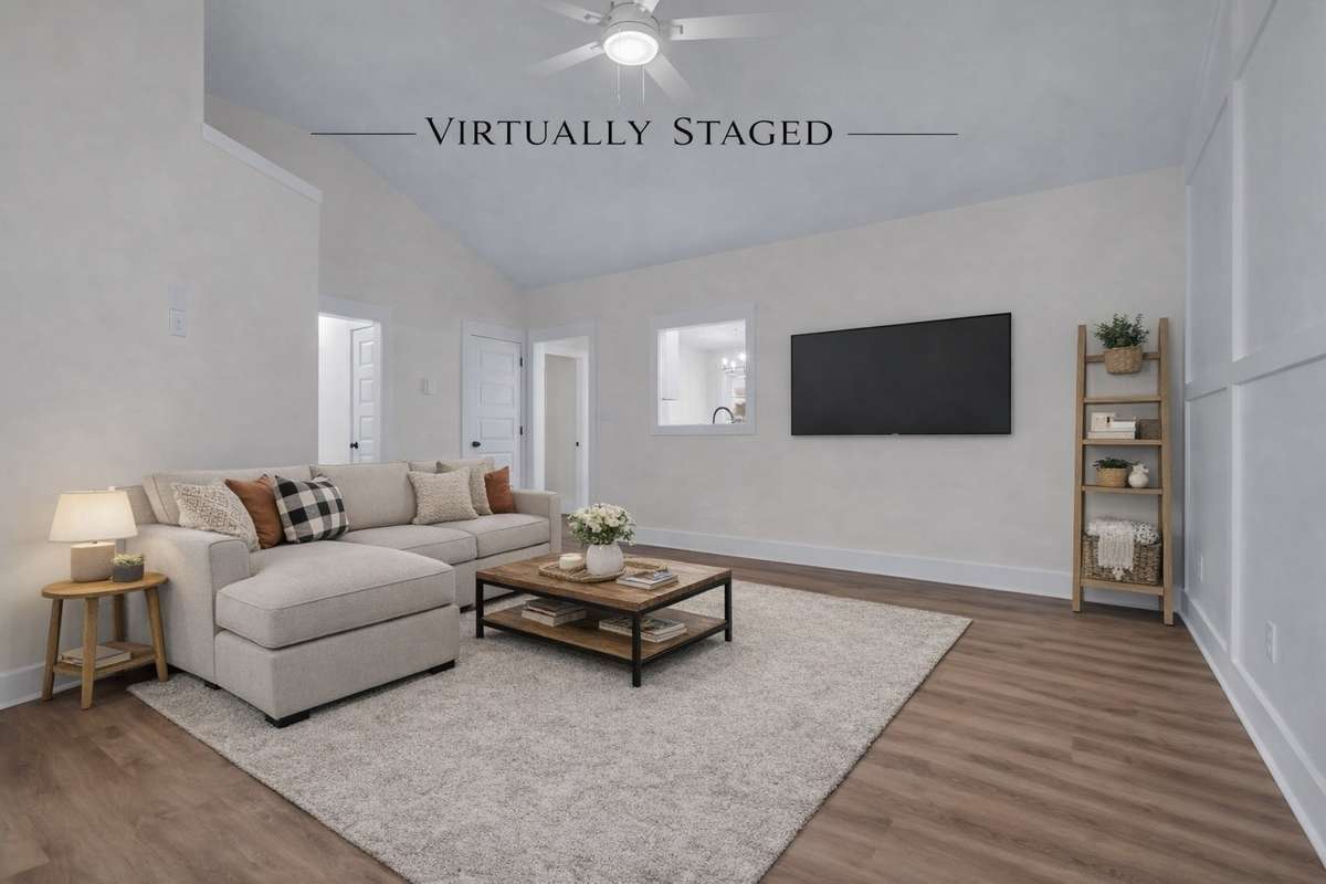 Comfortable gathering space with designated TV wall and natural light.