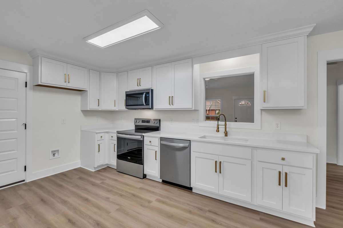 Updated kitchen featuring quartz countertops and stainless steel appliances.