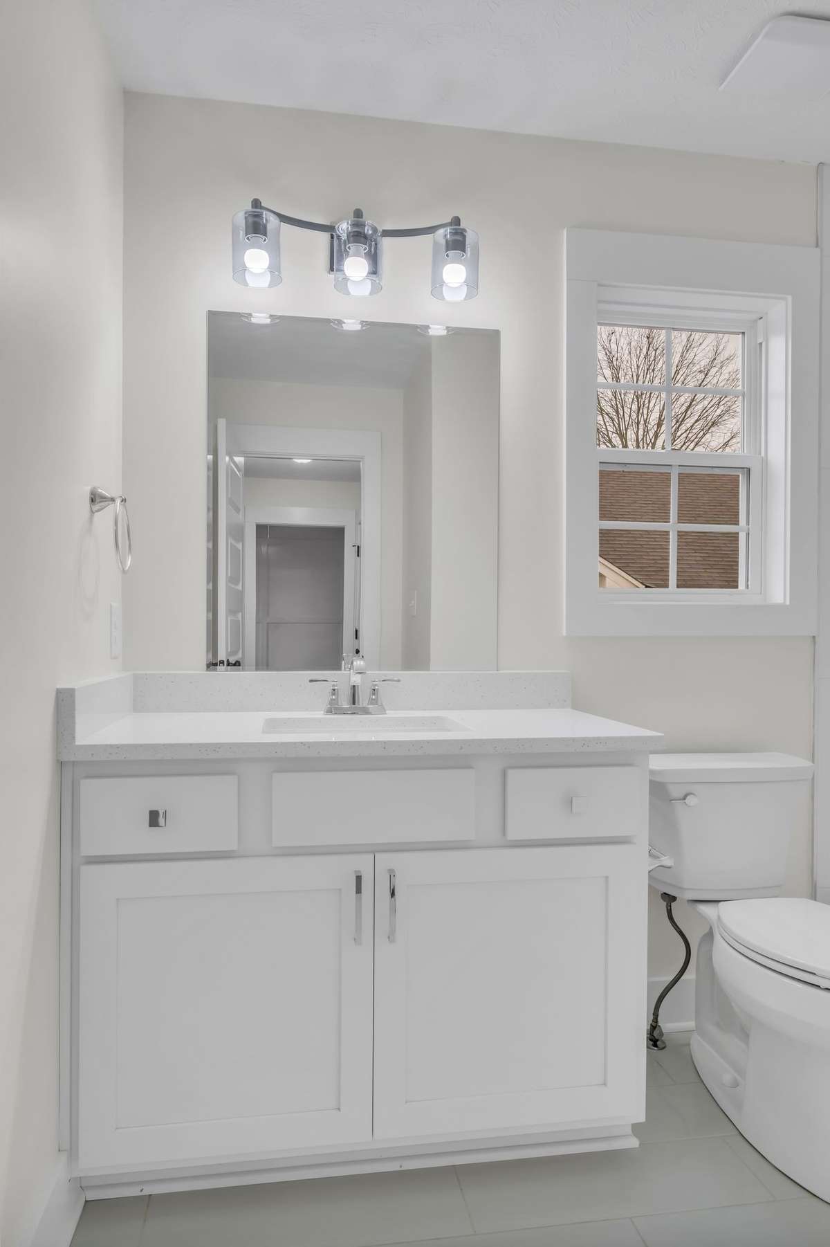 Secondary bath with quartz countertop.