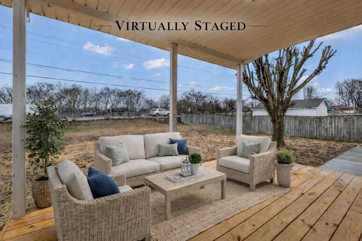 Covered back deck perfect for relaxing or entertaining year-round.