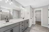 Picture of model home and not of actual home being built.  Colors and selections may vary!  The home being built will have the oversized vanity with two sinks and have a Separate Tile shower and tile surround tub.