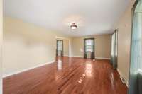 Another view of Living Room and wood Floors with lots of windows