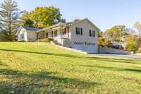 Side view of home with 2 car garage and paved driveway