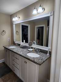 The primary bedroom features a large bathroom with double vanities and walk in closets.