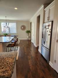 Another view of kitchen including fridge and pantry