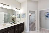 Double vanity in your primary bathroom with an extra-large closet.