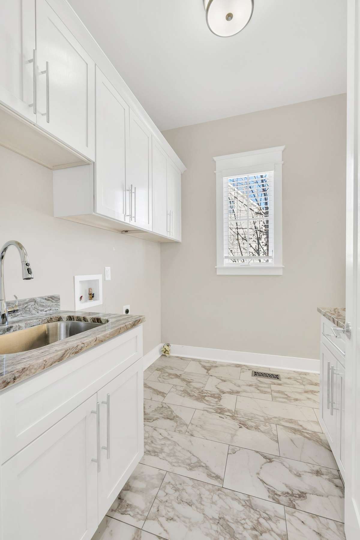 Large laundry room with cabinets and folding area