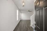 Foyer entry with coat closet and stairs tucked away.  **All photos are of a previously constructed Covington floorplan.**