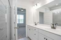 Double vanities, tile flooring, and cultured marble countertops in your primary suite.  **All photos are of a previously constructed Covington floorplan.**