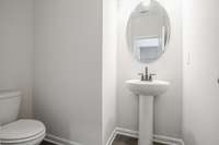 Powder room downstairs off main living area for guests.  **All photos are of a previously constructed Covington floorplan.**