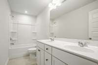 Full bathroom upstairs with double vanities. Tiled shower optional.  **All photos are of a previously constructed Covington floorplan.**