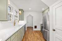 Newly renovated kitchen with quartz countertops, new hardwood flooring and new stainless appliances