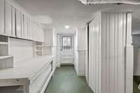 Work bench area complete with cabinet storage in basement