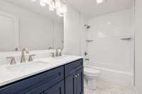 Fully renovated full bath on main level complete with 2 sinks, new doulbe vanity, new floor and tub tile.