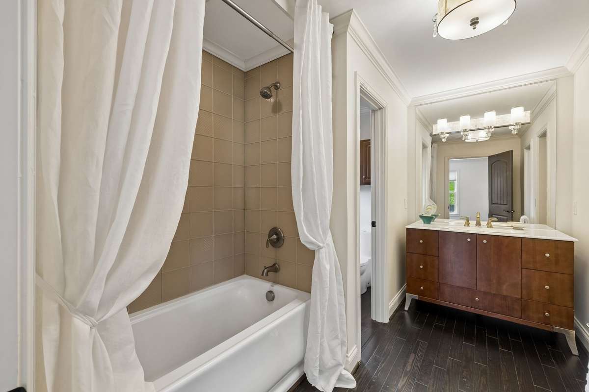 Jack and Jill Bathroom shared with bedroom #2. Luxury bathroom with deep soaker tub and Italian glass tile, designer single vanity.