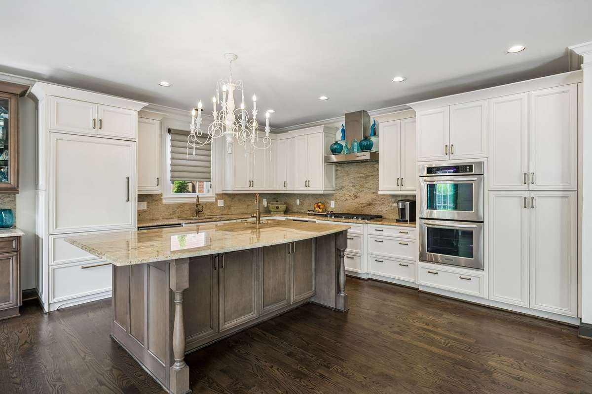 Double ovens, warming drawer, and 36" gas 5 burner cooktop (March 2025) with Meile hood vent with glass shelves.