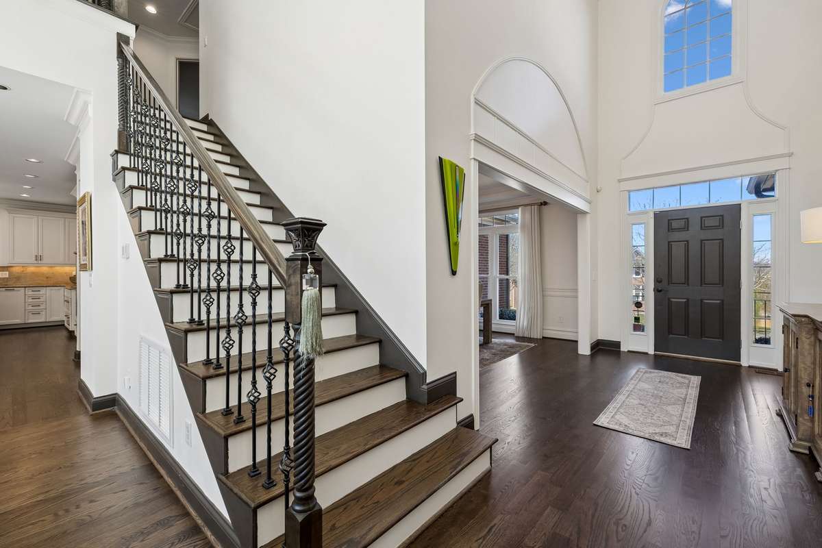 Solid oak steps, oak railing, oak balusters and iron spiral spindles lead to the second floor.