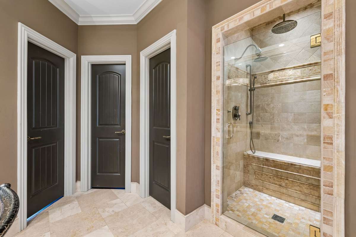 Travertine and honey onyx continue in the shower.