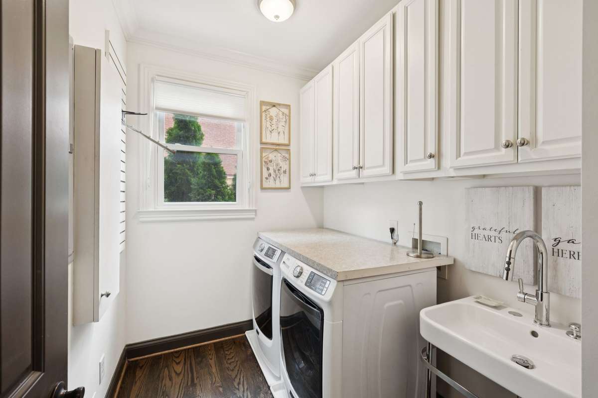 Custom cabinets and wall boarding for hooks to hang clothes. Built-in drop down ironing board on wall. Designer sink with stainless legs.