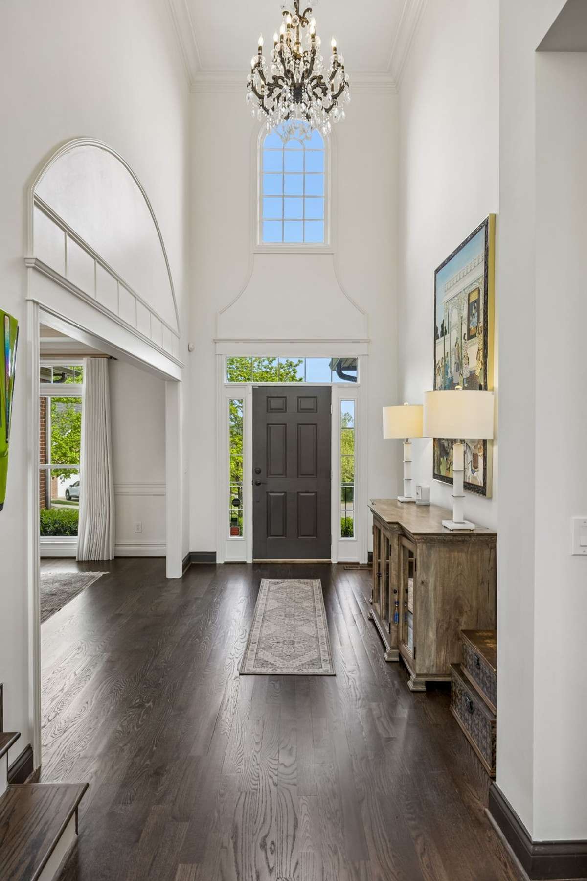 Two story entry with 18' ceilings, custom moldings and trim throughout, and designer lighting.