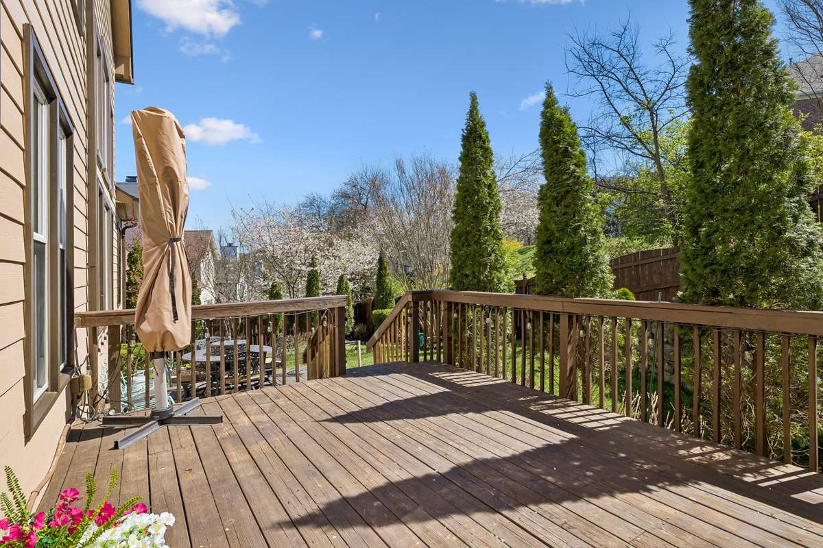 Enjoy outdoor living on the wood deck with tree lined fenced yard.