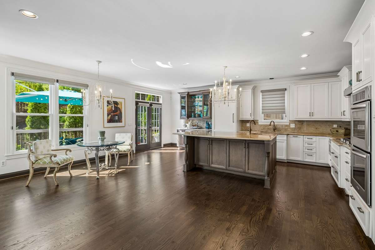 The kitchen has high-end luxury finishes. Custom cabinets with soft close drawers. Large island with additional storage, cook's nook and two electrical outlets.