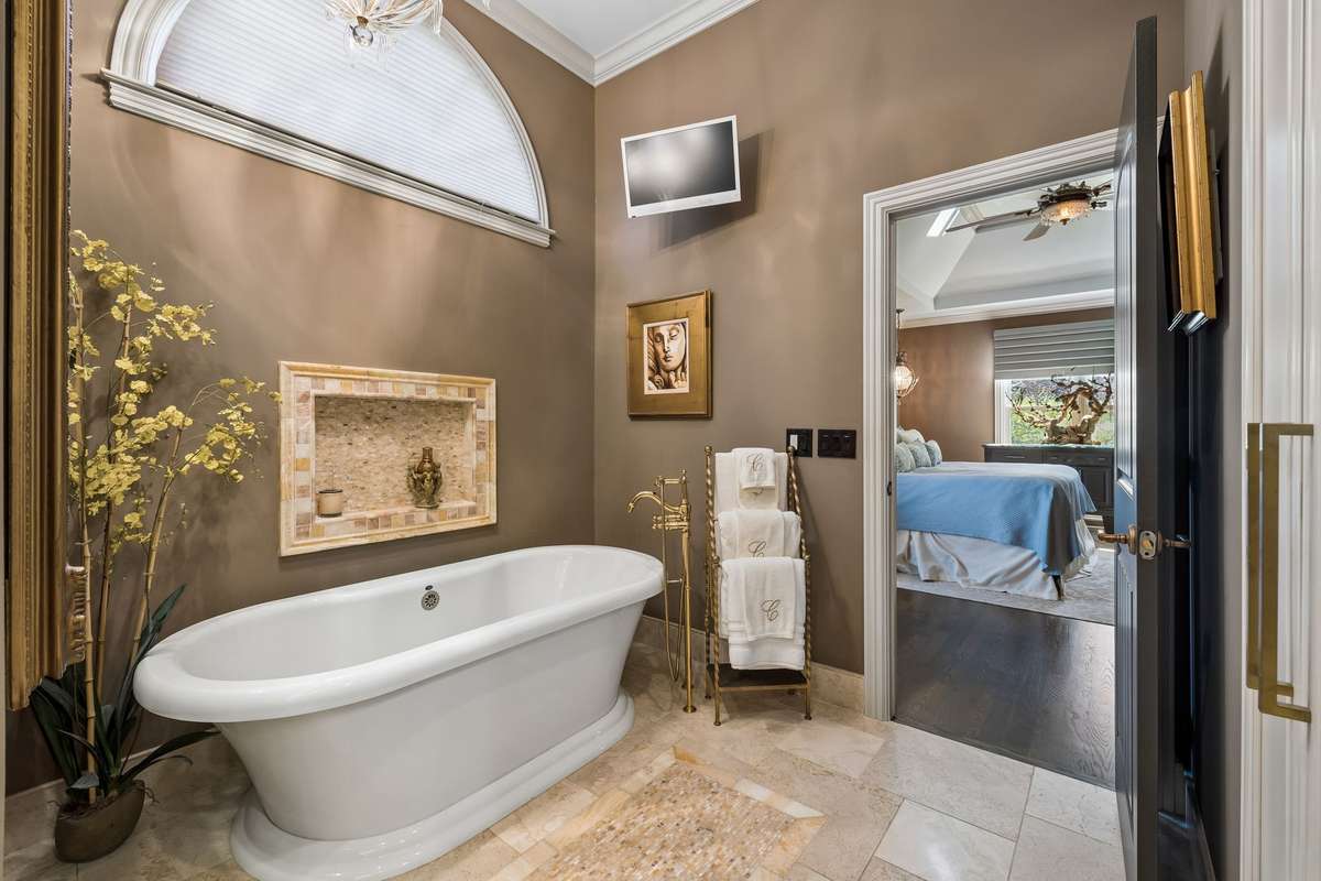 24 K Gold plated designer fixtures at free standing soaking tub and sinks. Spacious linen closet.