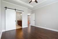 Barn door that leads into the Primary Ensuite