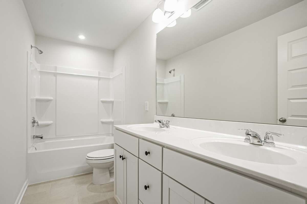 Full bathroom upstairs with double vanities. **All photos are of a previously constructed Covington floorplan.**