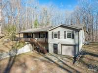 Front of home with door to basement/garage.