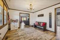 Entry/living room with doorway to family room and kitchen.
