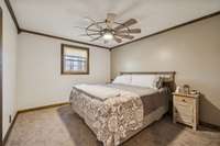 Primary bedroom with ceiling fan.