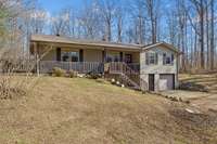 Front of home with wrap around porch.