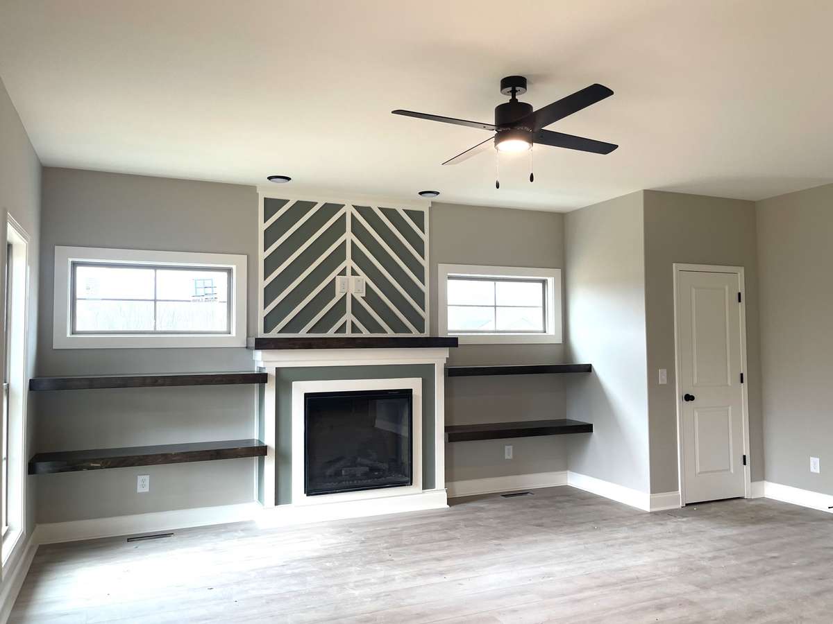 Great Room Features Electric Fireplace, Custom Trim, Floating Shelves & Laminate Flooring...
