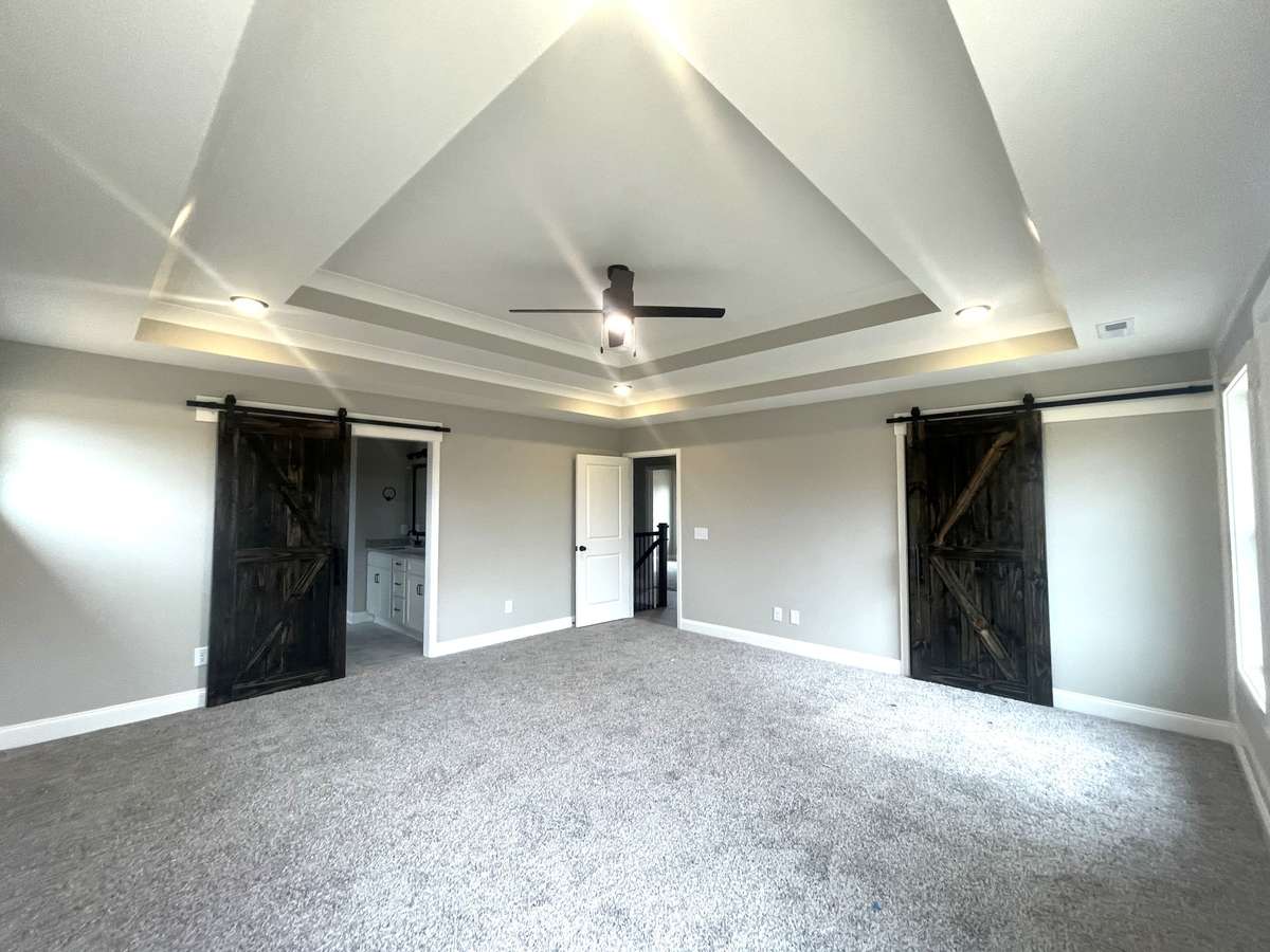 Owners Suite ...Check out trayed Ceilings & Barn Doors...